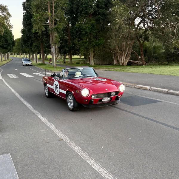 Classic Fiat 124 Spider displaying NSW Historic Vehicle Scheme (HVS) registration plates ending in 'J'.