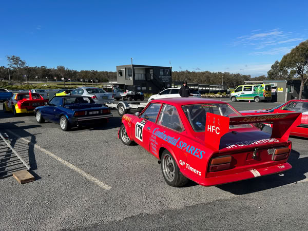 A lineup of classic racing Fiats featuring the 'Fiatorque' Fiat 124 Coupe track car alongside a standard X1/9 and a wide-body Fiat X1/9 Prototipo.