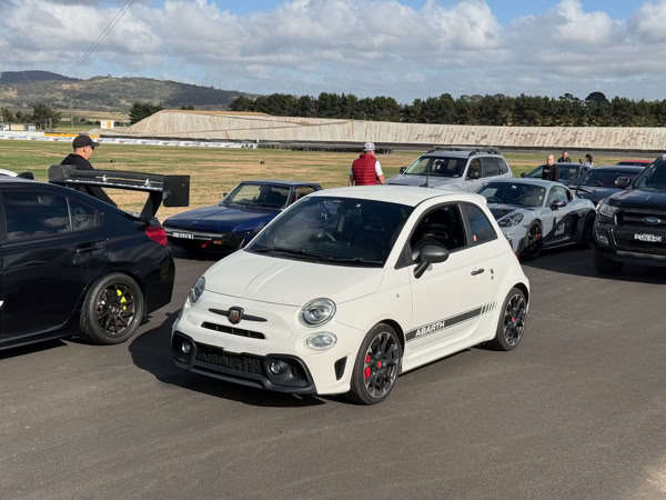 Modern Fiat Abarth 500 completing a sighting lap at One Raceway to familiarise with track corners and conditions.